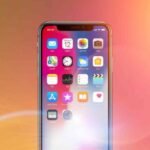 Smartphone glowing with AI visuals, representing OpenAI’s Sora video app growth milestone